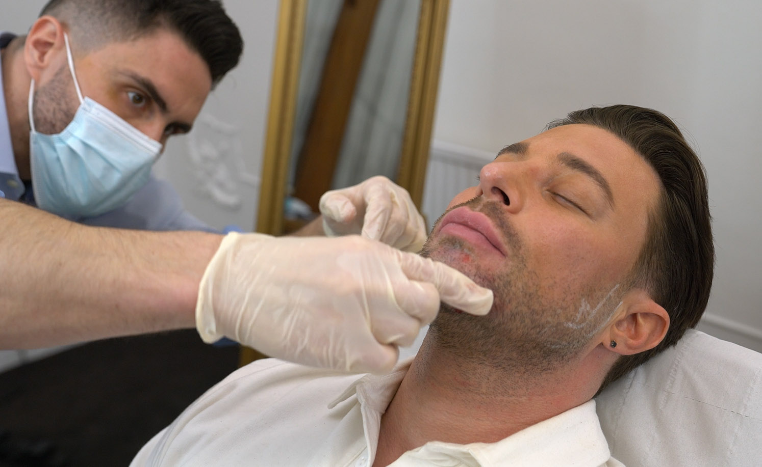 James Olding demonstrating a facial assessment in clinic