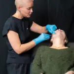 Dr Raquel Amado is performing a live demonstration during Interface Expo. She is injecting the face of a patient model.